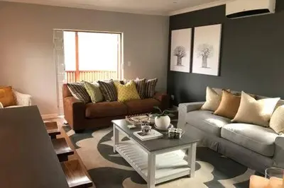 a living room with a couch and a table at Winner in the Winelands in Franschhoek