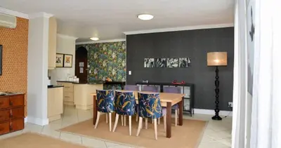 a kitchen and dining room with a table and chairs at Church Street Luxury Apartments in Stellenbosch