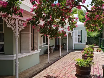 a street of houses with pink flowers at La Rochelle in Wellington