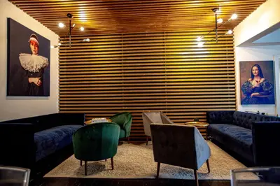 a living room with couches and a table and chairs at Franschhoek Maison du Cap in Franschhoek