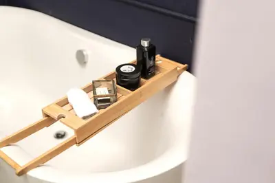 a bathroom with a wooden soap dispenser on a toilet at Franschhoek Maison du Cap in Franschhoek