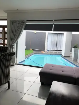 a swimming pool in a living room with a couch at Spoelklippies in Hermanus