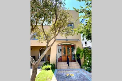 a house with a tree in front of it at Le Grec Wine Tram Apartment #1 in Franschhoek