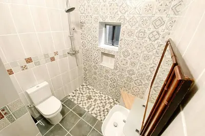 a small bathroom with a toilet and a sink at Le Grec Wine Tram Apartment #1 in Franschhoek