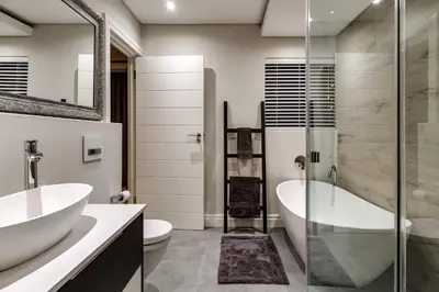 a bathroom with two sinks and a tub and a shower at Villa de luxe in Franschhoek