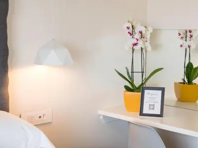 a bedroom with a desk with flowers on it at Penguino Guesthouse in Hermanus