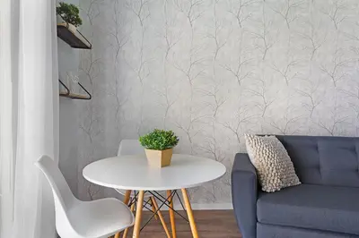 a living room with a table and a blue couch at Blouberg Studio Apartment in Bloubergstrand