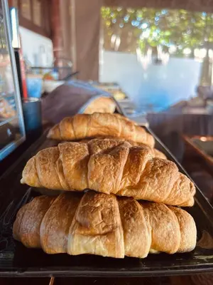 three loaves of bread on a tray on a table at Villa Helderberg in Somerset West