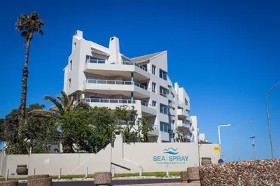 a large white building with acean spray sign on it at Spacious Luxury 3 Bedroom Apartment B401 Sea Spray in Bloubergstrand