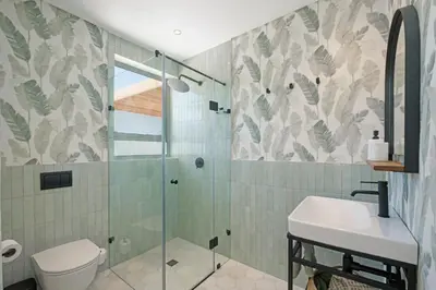 a bathroom with a shower and a toilet and a sink at Kite View Villa @2 in Cape Town