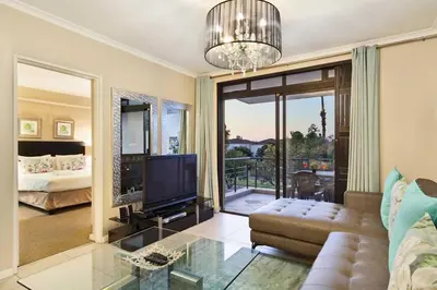 a living room with a couch and a television at Waterstone East F201 in Cape Town