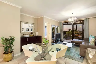 a living room with a table and a couch at Waterstone East F201 in Cape Town