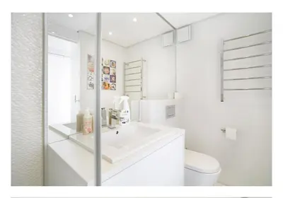 a white bathroom with a sink and a toilet at Designer Flat with scenic views in Cape Town