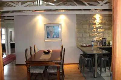 a dining room with a table and chairs at 20 On Percy in Cape Town