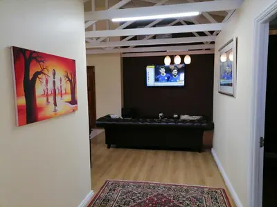 a living room with a couch and a flat screen tv at 20 On Percy in Cape Town