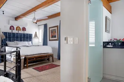 a bedroom with a bed and a walk in shower at No. 2 The Yard in Franschhoek