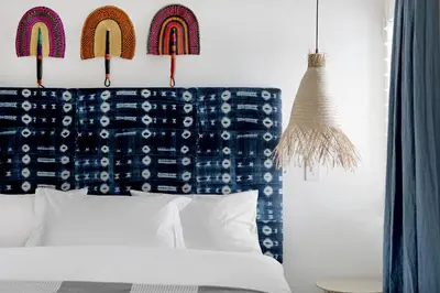 a bedroom with a bed with a blue headboard at No. 2 The Yard in Franschhoek