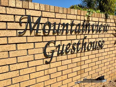 a brick wall with a sign that reads anaheim authorizationosity at Mountainview Guesthouse in Cape Town