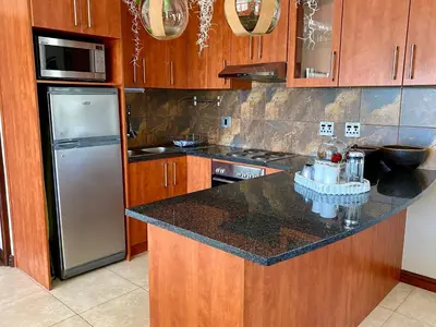 a kitchen with a refrigerator and a counter top at Mountainview Guesthouse in Cape Town