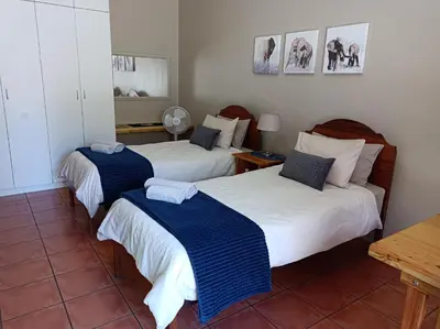 a bedroom with two beds with blue and white sheets at Kleine Nessie in Worcester