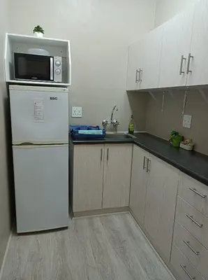 a kitchen with a white refrigerator and a microwave at Kleine Nessie in Worcester