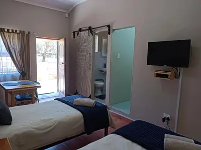 a bedroom with two beds and a large mirror at Kleine Nessie in Worcester