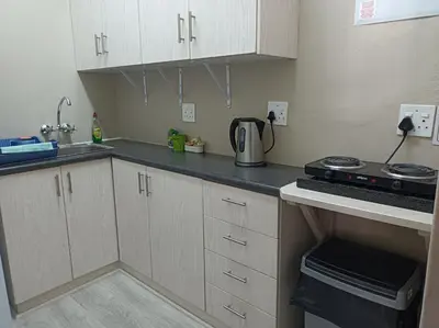 a small kitchen with white cabinets and a stove at Kleine Nessie in Worcester