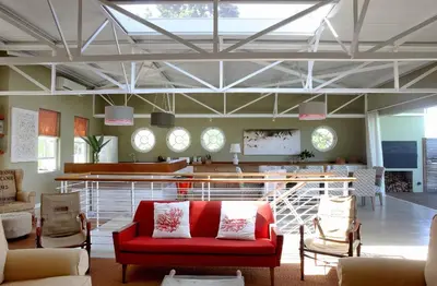 a living room with a red couch and chairs at The Library in Franschhoek