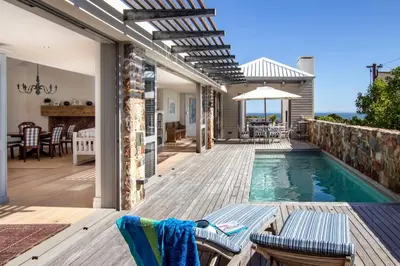 a house with a swimming pool and a patio at Splendour Hermanus in Hermanus