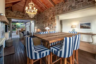 a dining room with a wooden table and chairs at Splendour Hermanus in Hermanus