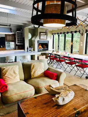 a living room with a couch and a table at Explorers Club in Franschhoek