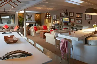 a living room with couches and a dining room at Explorers Club in Franschhoek