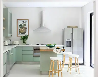 a kitchen with green cabinets and a refrigerator at Tugela in Franschhoek