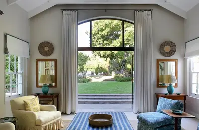 a living room with a large glass door to a yard at Tugela in Franschhoek