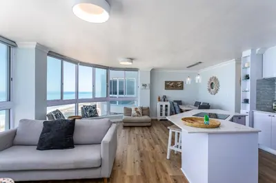 a living room with a couch and a table at Ocean View A1101 by CTHA in Bloubergstrand