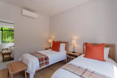 two twin beds in a room with a window at Minserie Collection in Stellenbosch