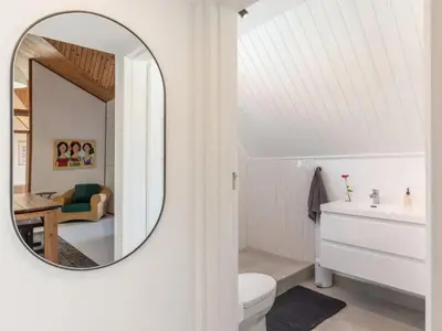 a bathroom with a mirror and a white toilet at Minserie Collection in Stellenbosch