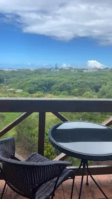 a table and chairs on a balcony with a view at Hemel in Hermanus Three bedroom Home in Hermanus
