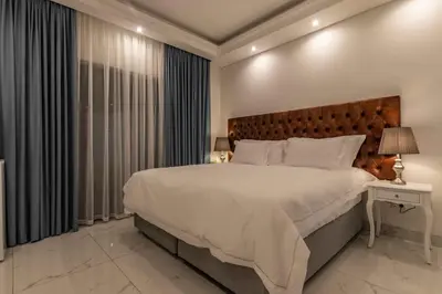 a bedroom with a large bed and a large window at Oceanway Boutique Hotel/Conference in Cape Town