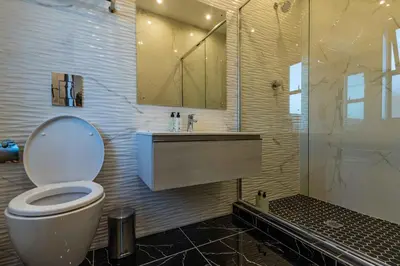 a bathroom with a toilet and a sink and a shower at Oceanway Boutique Hotel/Conference in Cape Town