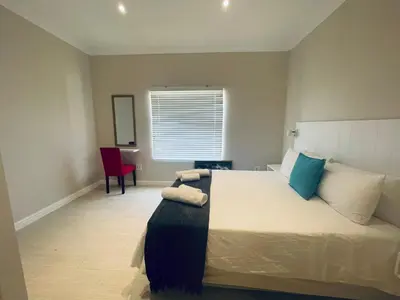a bedroom with a large bed with pillows on it at 147 Abalone-Inn in Hermanus