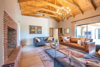 a living room with couches and a fireplace at Eikenhof Estate in Brackenfell