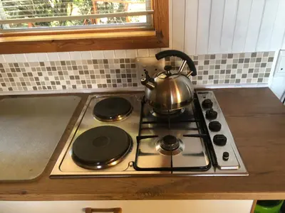 a tea kettle on a stove top in a kitchen at Little Haven 10 & 12 in Hermanus