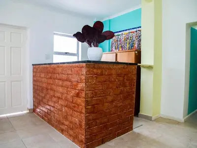 a brick wall with a vase on top of it at Relaxing guest House in the heart of Ndabeni in Cape Town