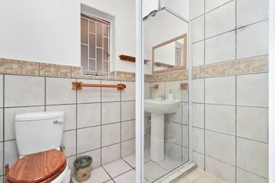a bathroom with a toilet and a sink at The Bohemian Guesthouse in Cape Town