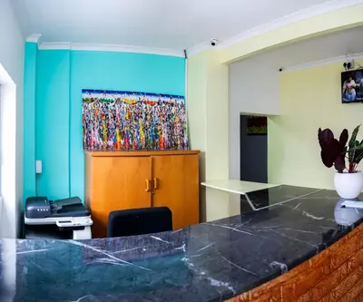 a room with a counter and a painting on the wall at Relaxing Guest House in the heart of Ndabeni in Cape Town