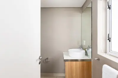 a bathroom with a sink and a mirror at Horizon Bay 301 by CTHA in Bloubergstrand