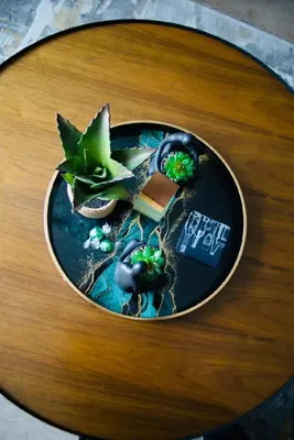 a table with a plate with a plant on it at Rose Gold @The Winchester in Cape Town