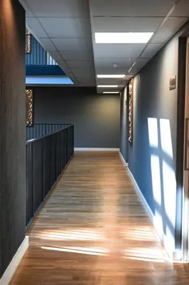 an empty hallway with a wooden floor in a building at Rose Gold @The Winchester in Cape Town