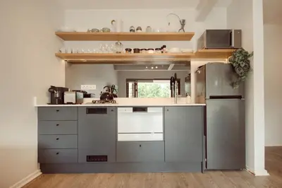 a kitchen with stainless steel appliances and a refrigerator at Luxury on Dorp in Stellenbosch